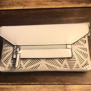 Brand new white clutch w/ laser cut-out detail. Zipper in back for phone.